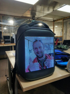 Jim's face on an LED backpack.